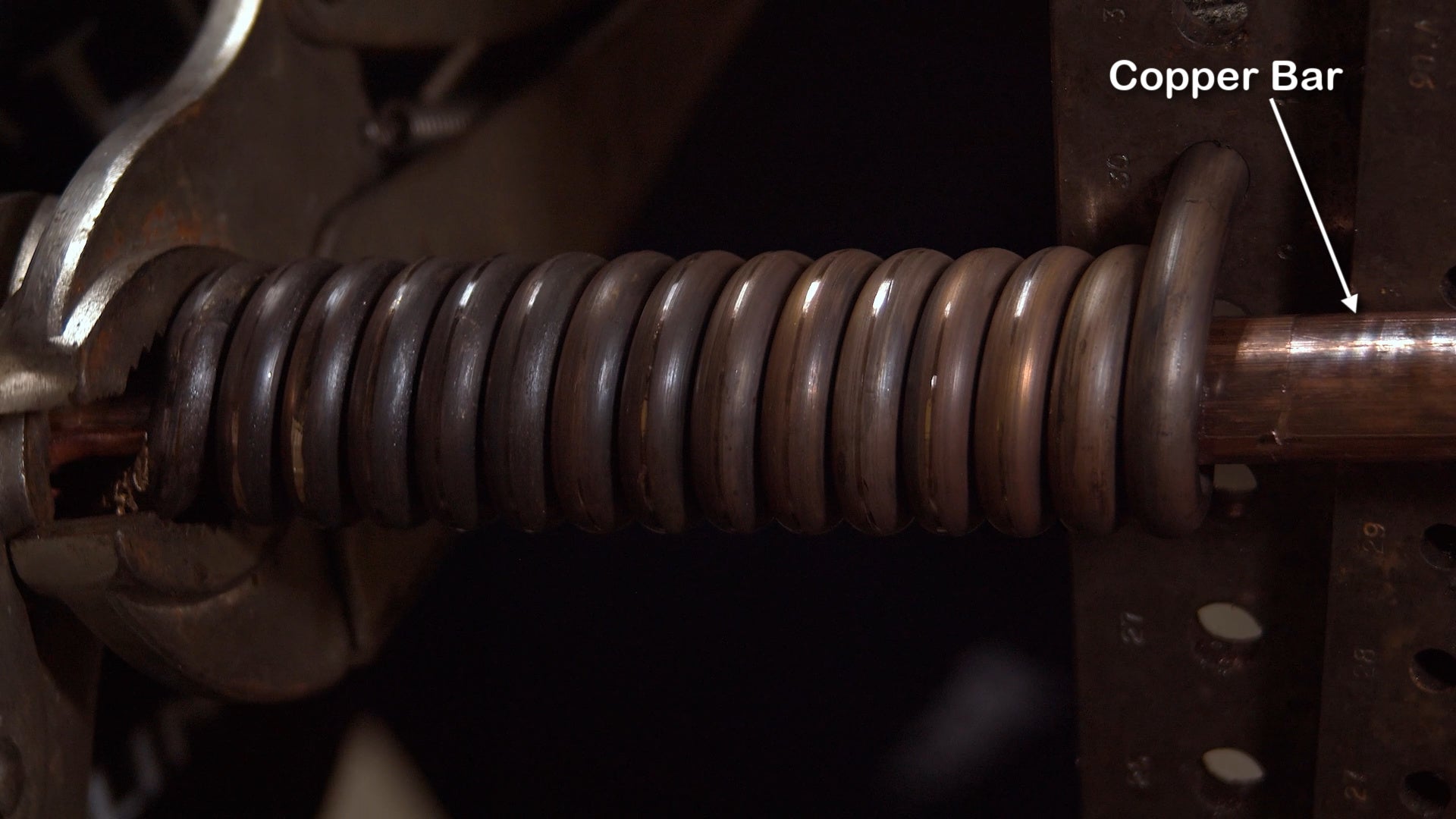 gold coil around copper bar